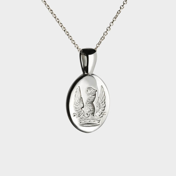 An oval signet pendant necklace with a family crest seal engraving.